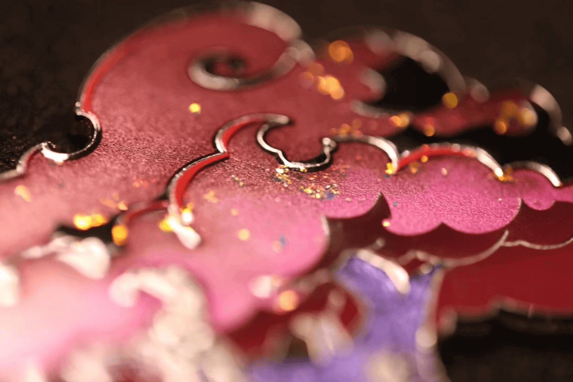 glitter-anime-wizard-hard-enamel-pin Macro shot of a custom fantasy anime enamel pin with raised silver edges and textured fill – emphasizing the tactile quality that makes pins desirable collectibles.