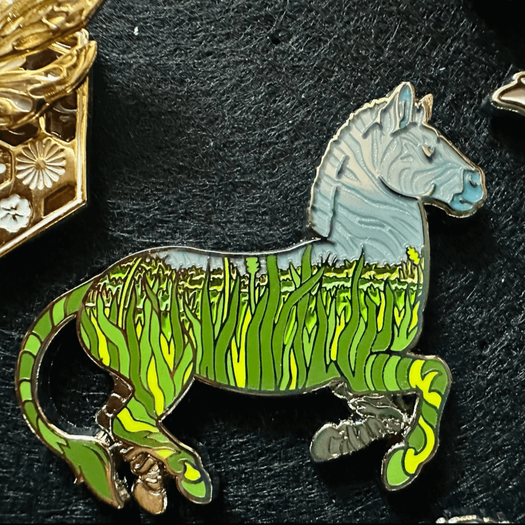 Creative Custom Enamel Pin Design | Animal Lapel Pin Creative custom enamel pin featuring zebra and grassland design, high-quality lapel pin with nature-inspired artwork