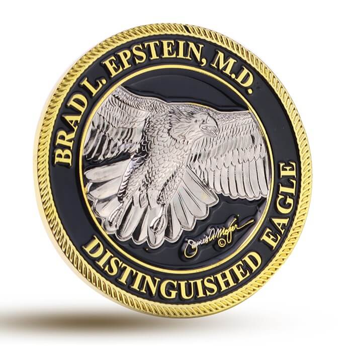 This eagle challenge coin is custom made for personal honor recognition, featuring a silver bald eagle with detailed relief texture symbolizing strength and distinction. The outer ring is engraved with “BRAD L. EPSTEIN, M.D.” and the title “DISTINGUISHED EAGLE,” finished with a gold rim and black background, creating a premium custom challenge coin for professional achievement awards.