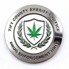A humorous challenge coin featuring the Tift County Sheriff's Office emblem, with a contrasting cannabis leaf in the shield design. The ironic use of a drug symbol in a law enforcement badge adds a playful twist to traditional challenge coin designs, making it perfect for unique, satirical collections.