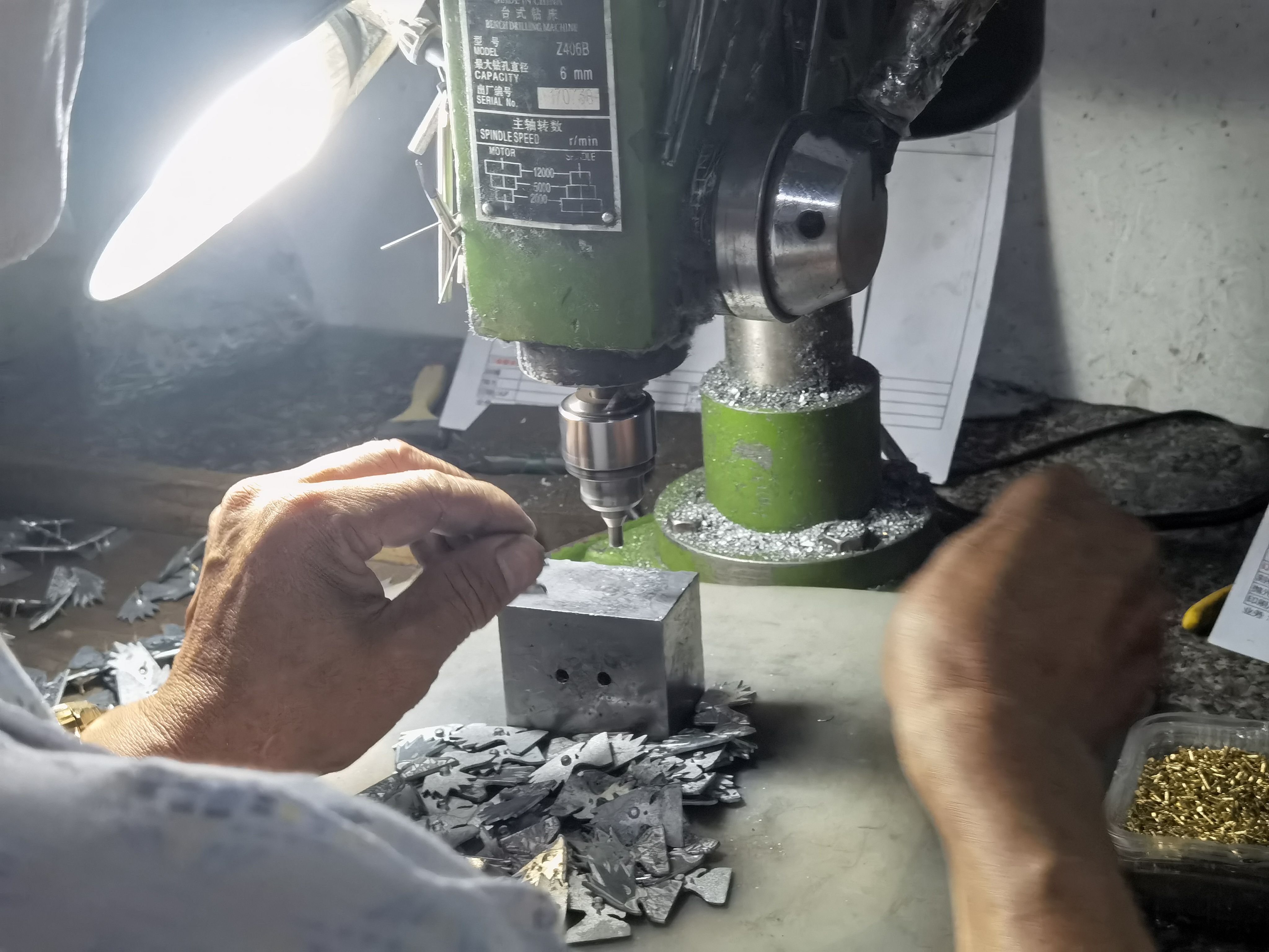 Attaching rivet needles and clutches to the back of custom lapel pins and brooches.