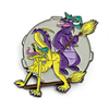 Funny dragon enamel pin featuring purple witch dragon on broomstick with tied yellow dragon in vibrant soft enamel colors