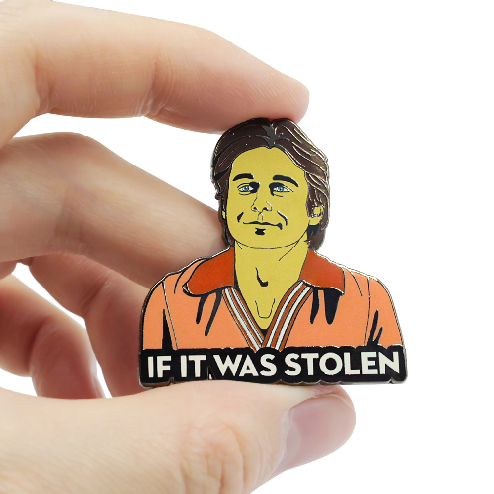 Close-up of custom anime enamel pin with stylized Johnny Depp portrait and 'If It Was Stolen' text – vibrant colors and metal backing
