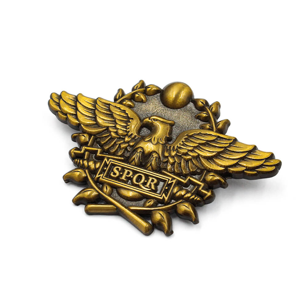Side view of antiqued gold eagle pin showing die cut metal details