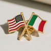 A crossed display of enamel lapel pins representing the USA and Italy flags. The USA flag has red and white stripes with blue and white stars, while the Italy flag features green, white, and red vertical stripes. These pins are commonly used for cultural exchanges, commemorative events, or as accessories for individuals from both nations.