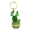 Enamel cactus keychain with 'HUGZ!' tag and pink pom pom charm on gold ring