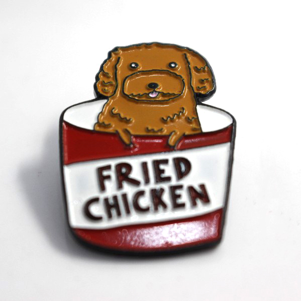 Custom soft enamel lapel pin showing a cute cartoon dog inside a fried chicken bucket, funny food themed enamel pins perfect for cool lapel pins and personalized enamel pins