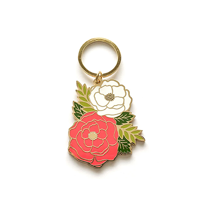 Enamel keychain showing pink/red and white peony flowers with leaves