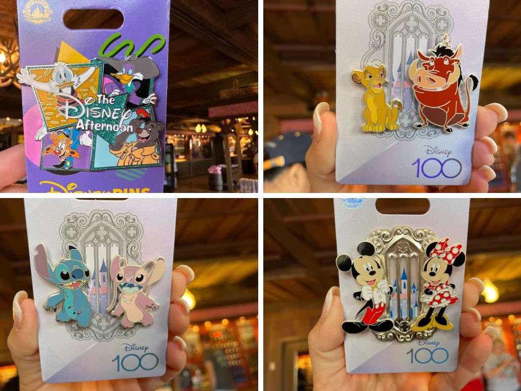 Assorted licensed Disney 100th anniversary collectible pins featuring popular characters like Mickey Mouse, Simba, and Stitch.