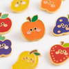 Hard enamel lapel pin with orange apple design, gold edging and cute cartoon details, shown as custom enamel fruit pin