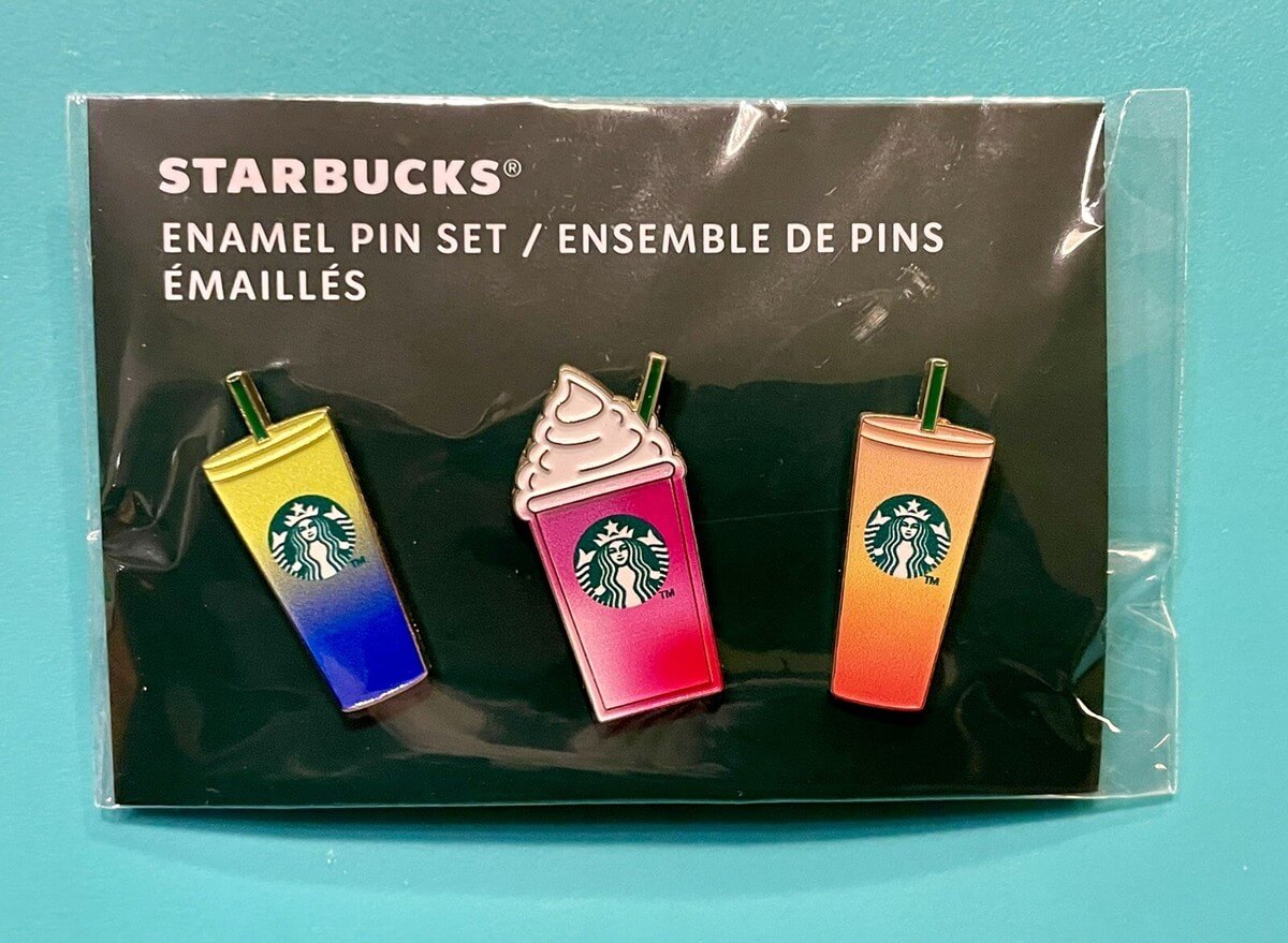 Starbucks enamel pin set featuring three colorful drink cup designs, each with the iconic Starbucks logo.
