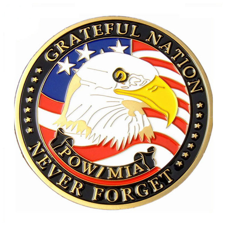 A commemorative POW/MIA challenge coin featuring an American bald eagle under a US flag. The gold-rimmed coin is inscribed with 'GRATEFUL NATION' and 'POW/MIA NEVER FORGET' to honor and remember prisoners of war and those missing in action.