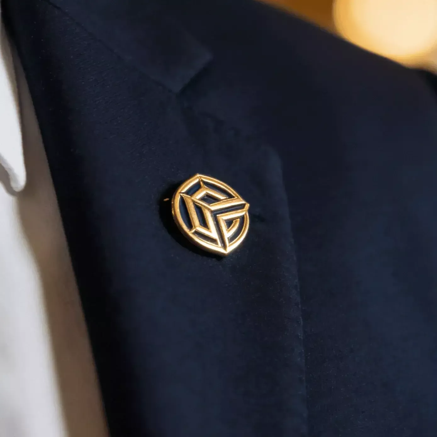 Gold Lapel Pin on Suit Jacket