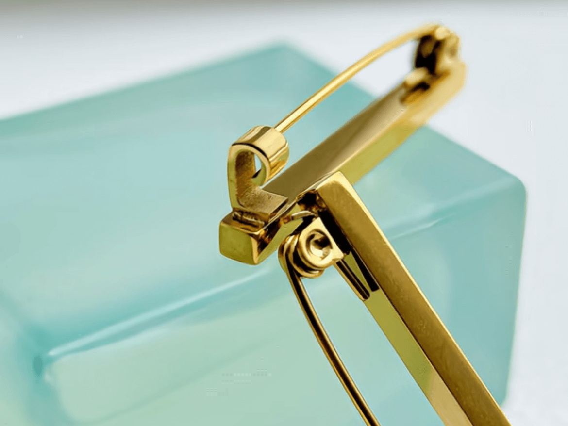 Gold safety pin brooch clasp detail