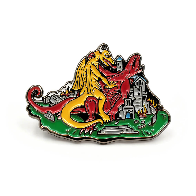 Anime enamel pin featuring fire-breathing cartoon dragon over ruined castle with green base and silver plating