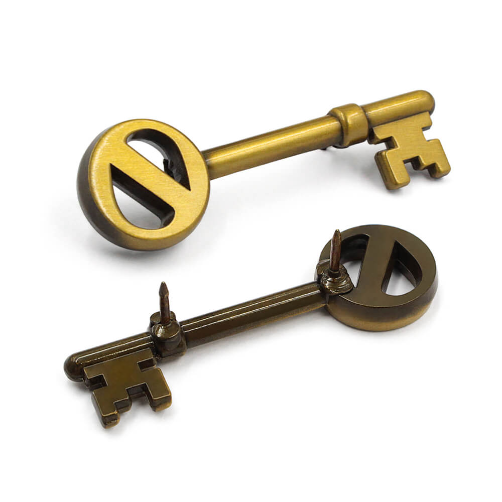 Set of vintage skeleton key lapel pins in antique gold and bronze finishes with 3D key design