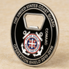 Custom US Coast Guard challenge coin bottle opener with Operation Shield 2015–2016 engraving, COMDAC marking, central shield emblem, and durable metal construction for military commemorative use