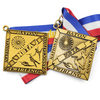 Close-up of GUGLE custom award medal showing gold diamond with NBTA banner, floral emblem, baton twirlers in action poses and detailed engraving