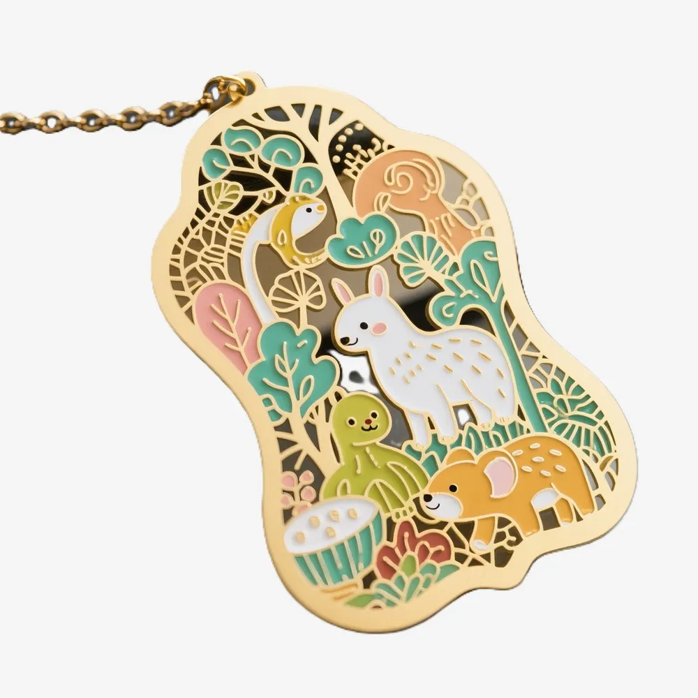 Gold cut-out metal bookmark featuring forest animals, plants, and mushroom details, placed on a book page.