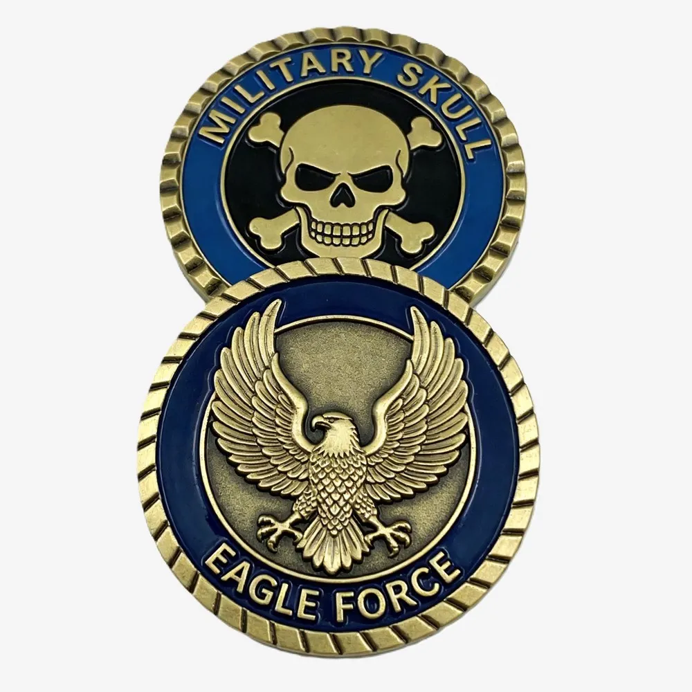 Two military challenge coins featuring soldiers, an aircraft, an aircraft carrier, an armored vehicle, a U.S. flag, and crossed swords.