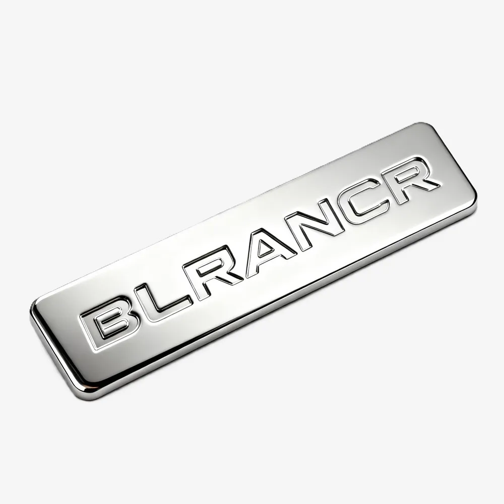 Silver rectangular metal nameplate with engraved “BLRANCR” lettering and a polished mirror finish.