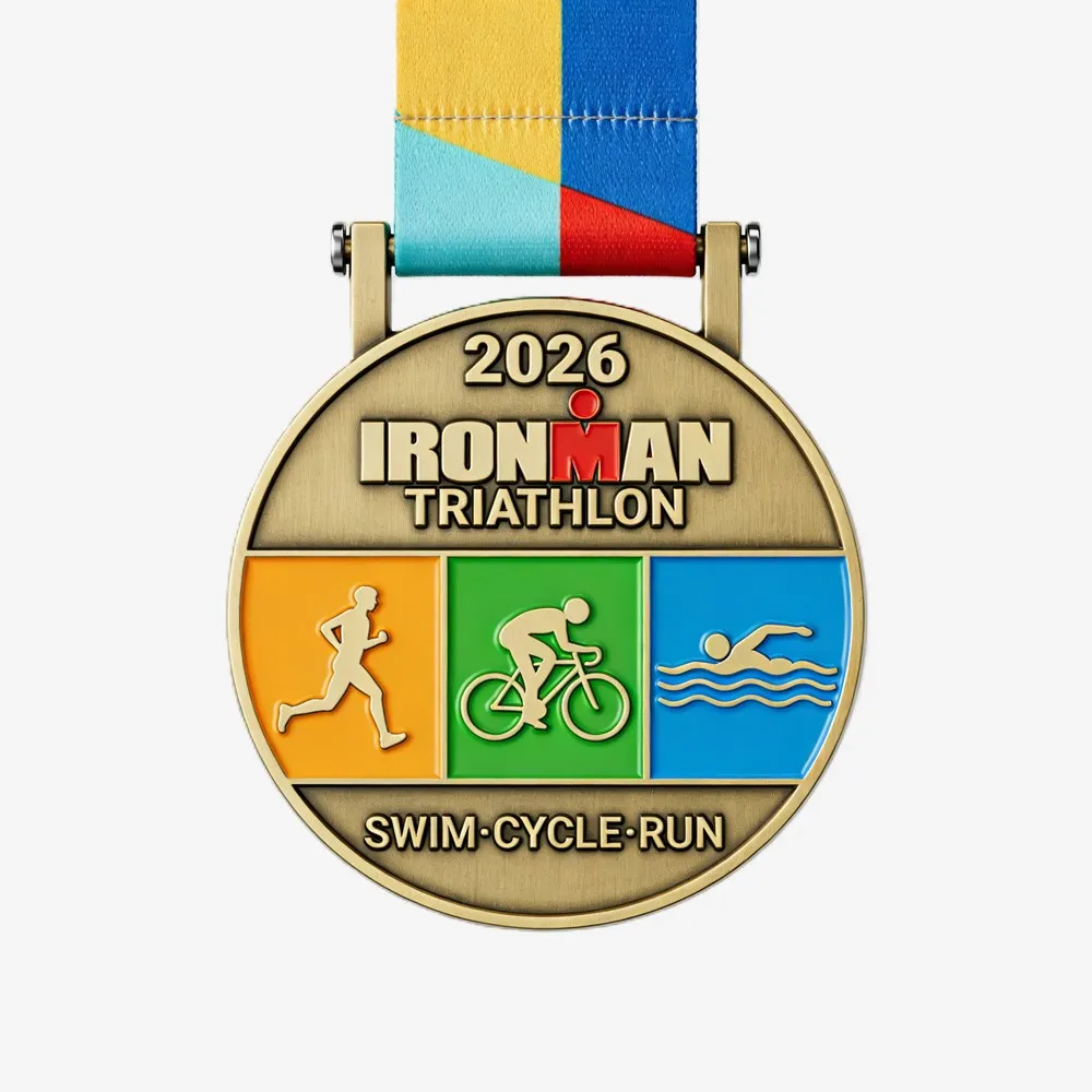 Round 2026 Ironman Triathlon custom medal with swim, cycle, and run icons, paired with a colorful ribbon.