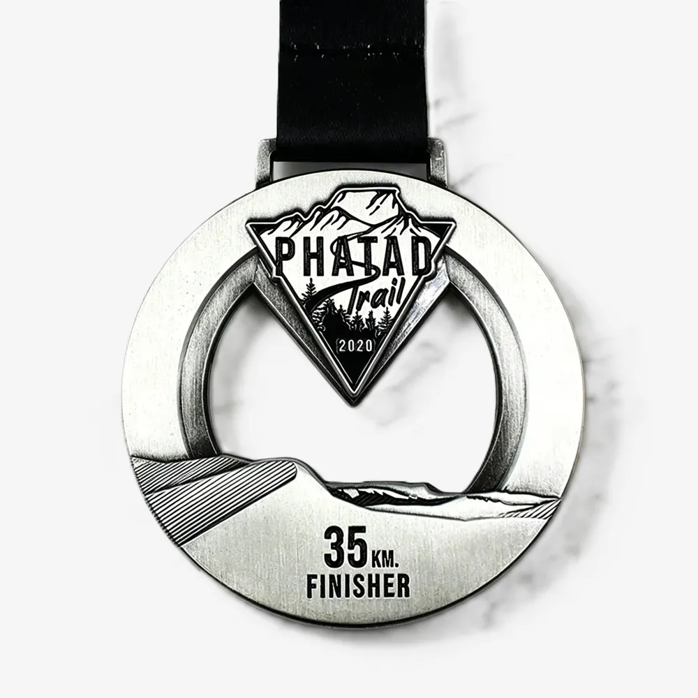 Phatao Trail 2020 35KM Finisher cut-out metal medal with mountain, forest, and trail details, paired with a black ribbon.