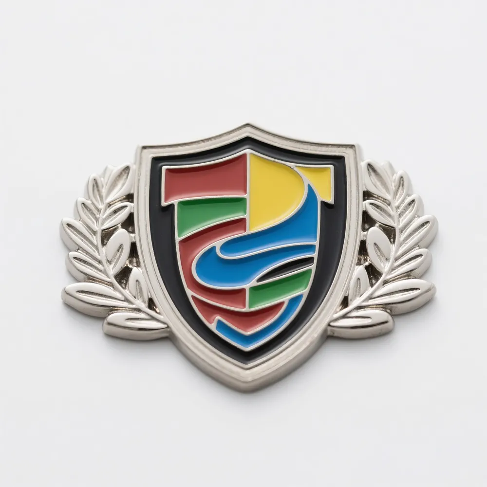 Silver shield-shaped corporate pin with a colorful abstract logo in the center and laurel branches on both sides.